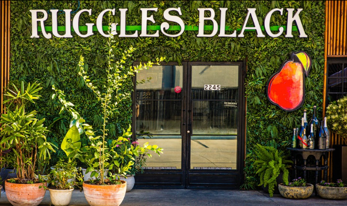 The Ruggles Black entrance on West Alabama Street, framed by a living green wall
